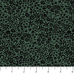 A close-up of a fabric pattern featuring black floral and leafy motifs on a muted sage green background, with a white ruler at the bottom showing scale.