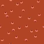 Pattern of small persimmons with dark centers on a brown background