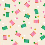 Colorful spool pattern on a beige background