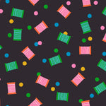 Colorful pattern of spool and polka dots on a dark background