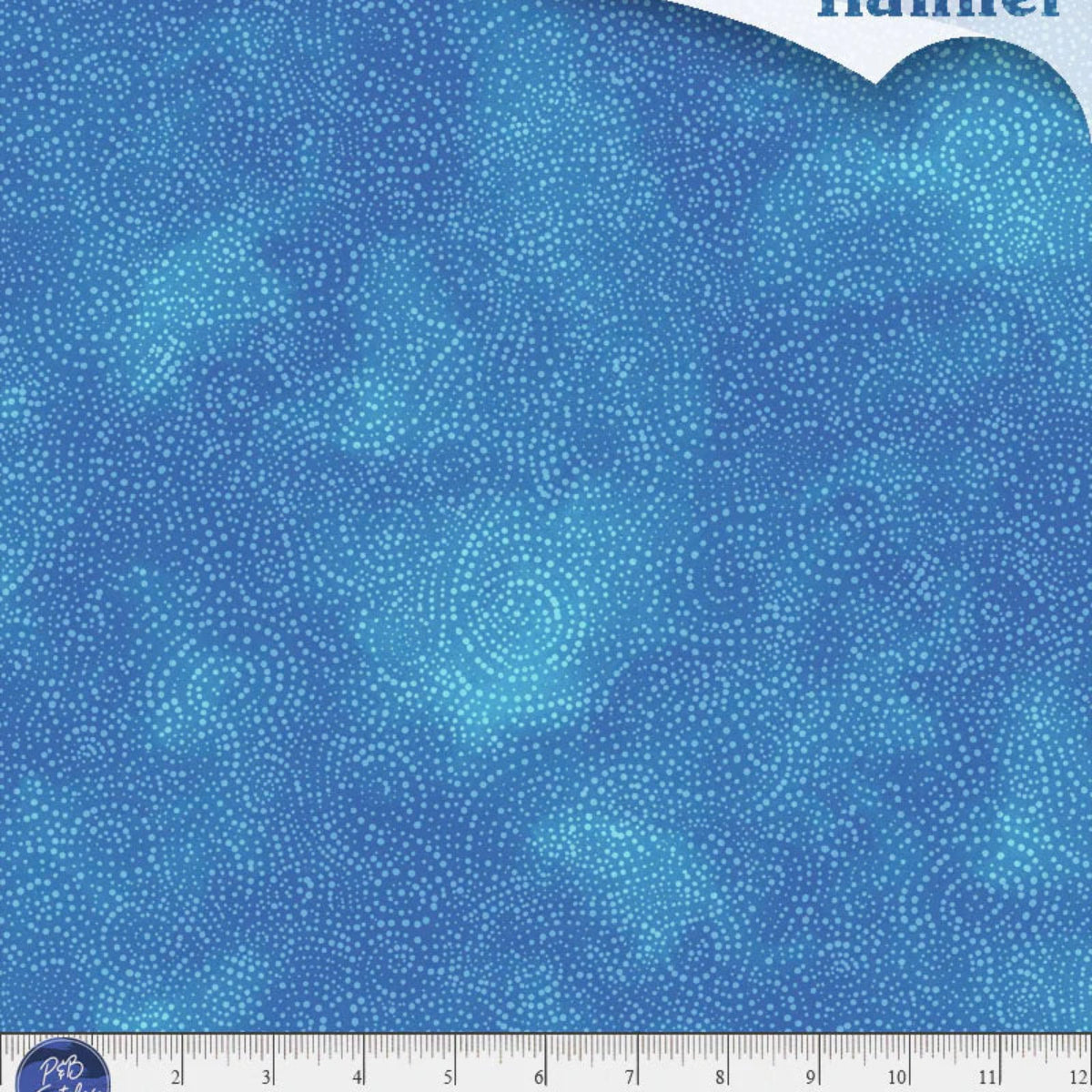 Blue flannel fabric with circular patterns and a ruler at the bottom for scale.