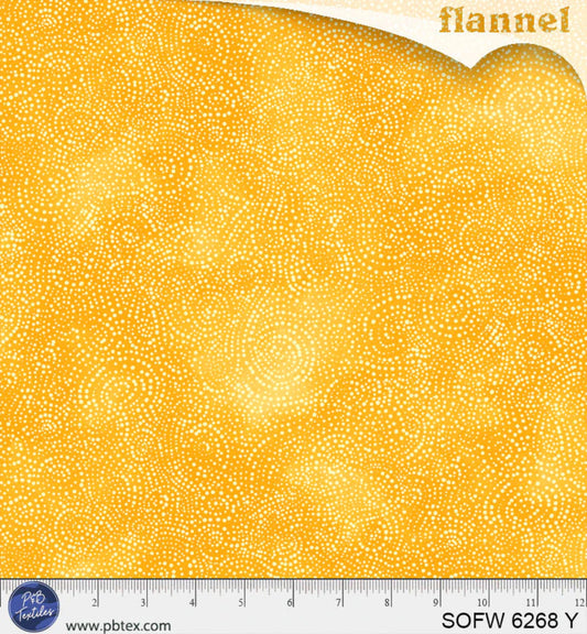 Yellow flannel fabric with a small white pattern and a ruler at the bottom for scale.