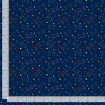 A close-up of a navy blue fabric with a repeating pattern of colorful constellations and small stars, shown with a ruler along the left and bottom edges for scale.