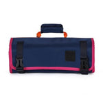 Navy and pink roll-up bag with black straps on a white background