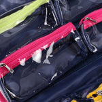 Clear plastic bags with pink and black zippers on a reflective surface