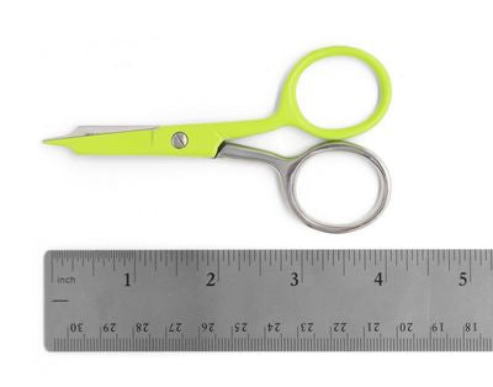 Bright lime green and stainless steel scissors positioned above a metal ruler on a white background.
