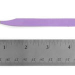 A pair of purple-handled angled tweezers shown above a metal ruler for scale on a white background.