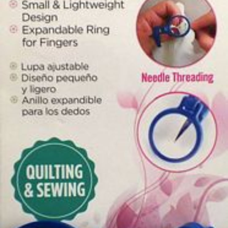 ToolTron Attachable Thumb/Finger Magnifier in its retail packaging, featuring a blue magnifying ring and a blue adjustable clamp on a pink and white background.