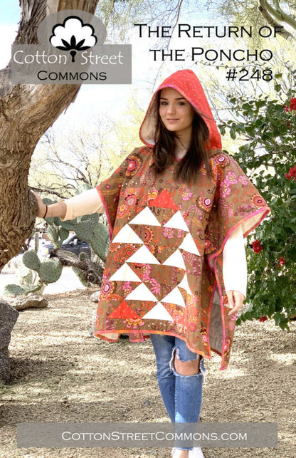 Woman wearing a floral poncho with a hood in a natural setting, promoting Cotton Street Commons.