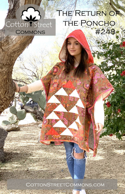 Woman wearing a floral poncho with a hood in a natural setting, promoting Cotton Street Commons.