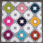 Vintage Tiles quilt featuring colorful geometric star blocks in a modern repeating layout.