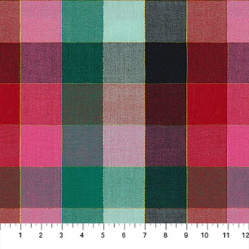 Green, pink, red and black checker fabric with a ruler for scale.