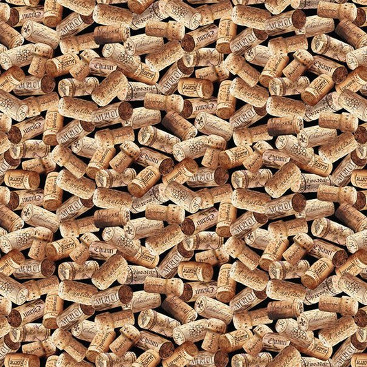 Tossed wine corks on a black cotton fabric.
