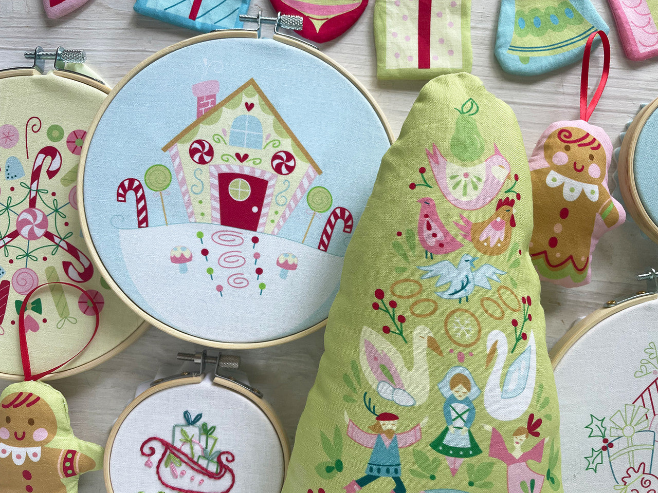Embroidery hoops with colorful stitched designs on a wooden surface