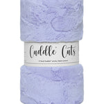 A folded lavender plush fabric wrapped in a white paper band labeled 'Cuddle Cuts'.