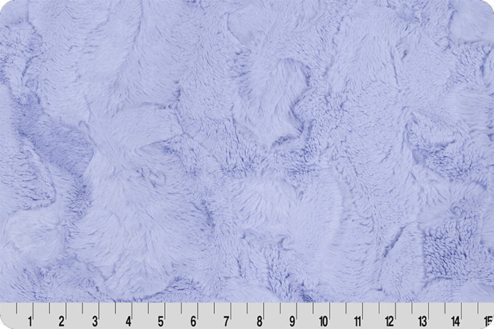 Light lavender plush faux fur fabric texture with a white ruler at the bottom edge showing measurements.