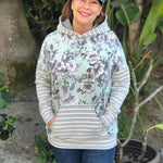 Outdoor view of the Del Mar Hoodie worn with a creative mix of prints for a fresh, updated look, showing the hooded style and front pocket