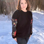 Outdoor winter view of the long‑sleeve Del Mar Top worn without a hood, showing the garment’s fit and sleeve style