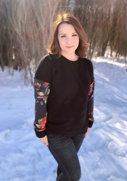 Outdoor winter view of the long‑sleeve Del Mar Top worn without a hood, showing the garment’s fit and sleeve style