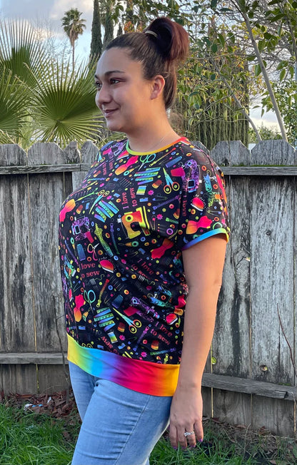 Outdoor view of the Del Mar Top worn in a yard setting, showing the garment’s fit and neckline without a hood
