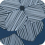 A close-up of a fabric or material swatch with a geometric floral-like pattern in navy blue, white, and dark gray, featuring alternating striped and solid petal shapes.