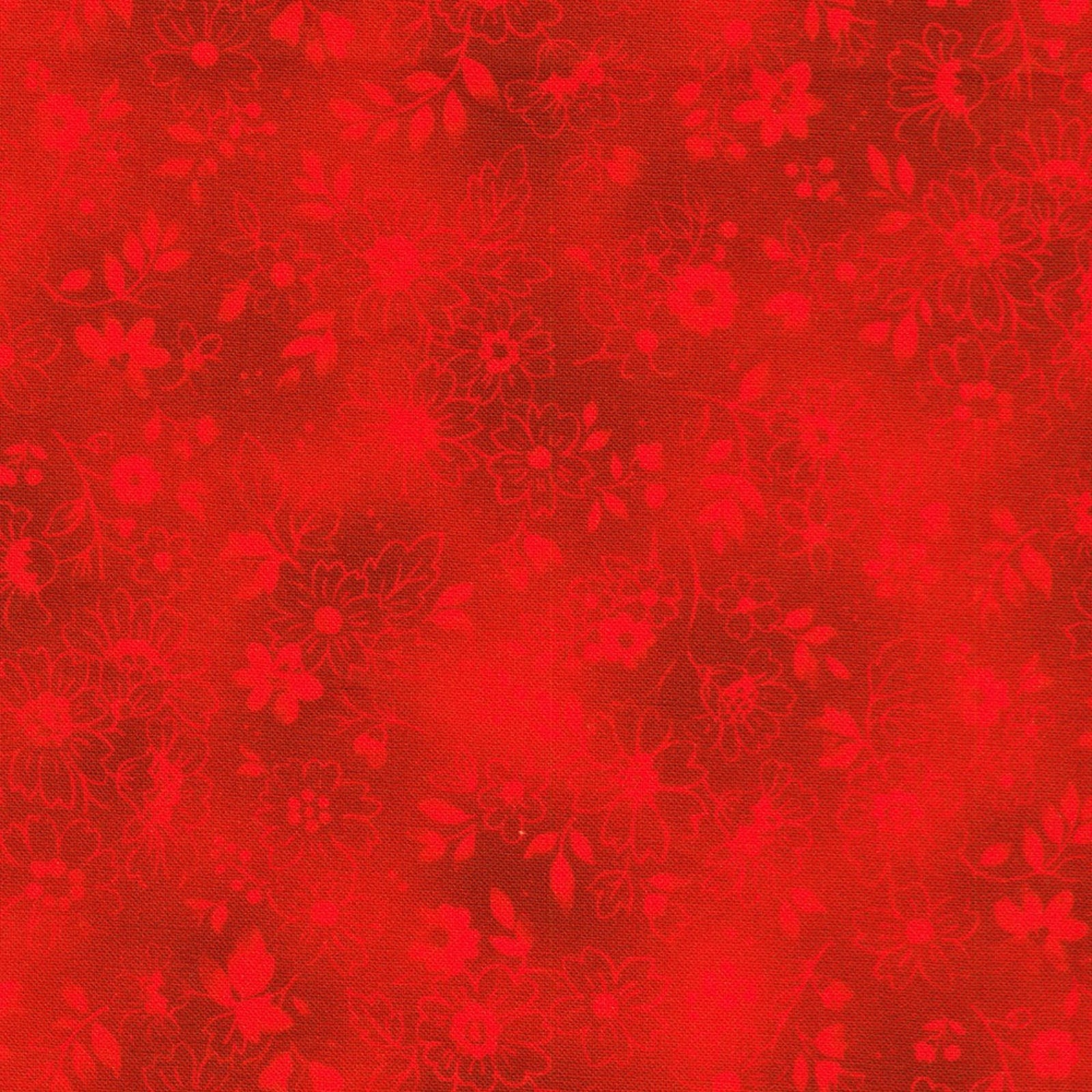 A close-up of a red fabric or material swatch with a tonal floral pattern in slightly darker red.