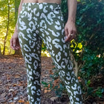 Outdoor active view of the Foxglove Leggings worn on a forest path, showing the above‑ankle length and supportive waistband