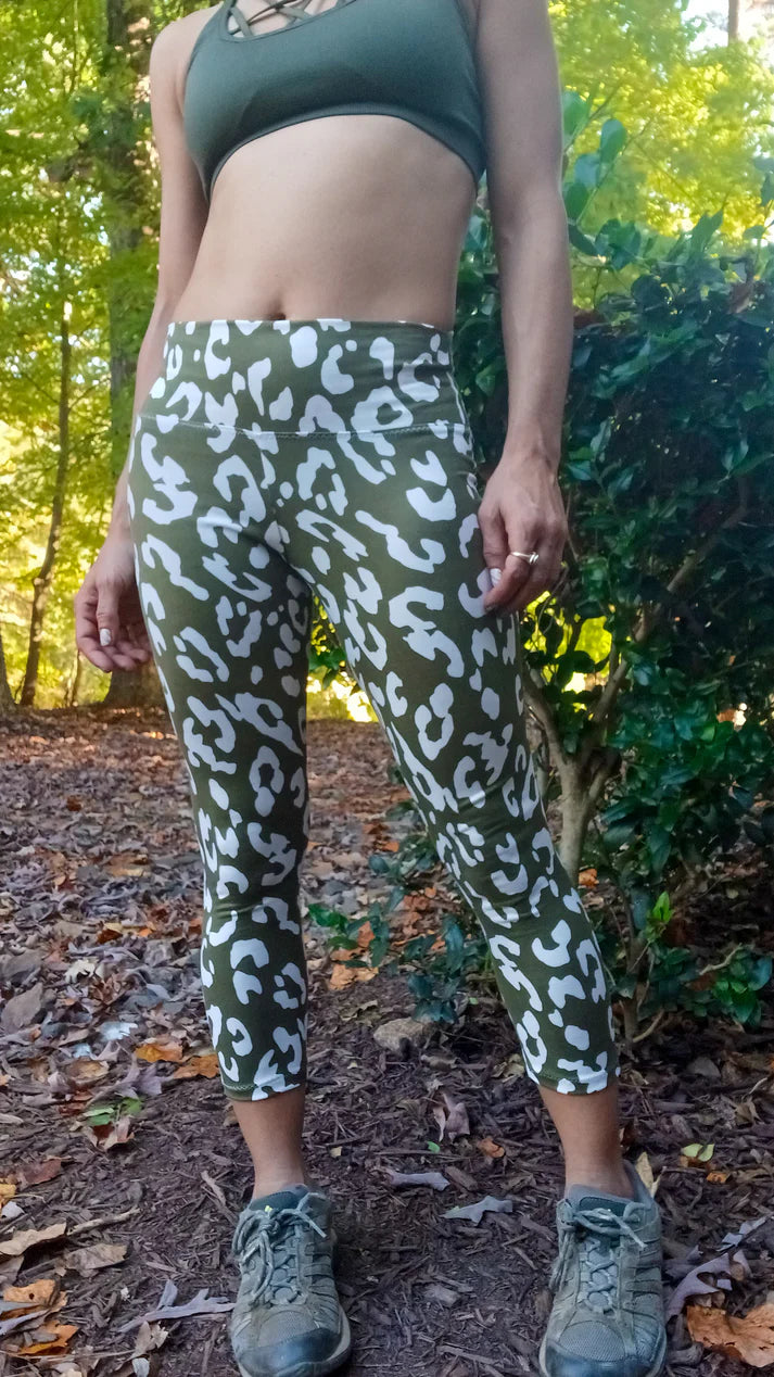 Outdoor active view of the Foxglove Leggings worn on a forest path, showing the above‑ankle length and supportive waistband