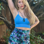 Outdoor view of the Foxglove Leggings shorts option worn in a garden setting, showing the fit and high‑waist style