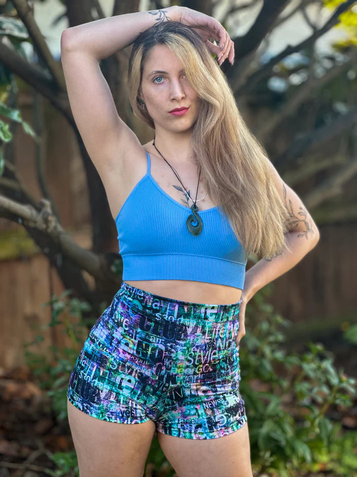 Outdoor view of the Foxglove Leggings shorts option worn in a garden setting, showing the fit and high‑waist style