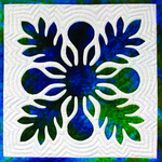 Hand‑appliquéd Hawaiian quilt block with layered blue and green fabric and echo quilting.