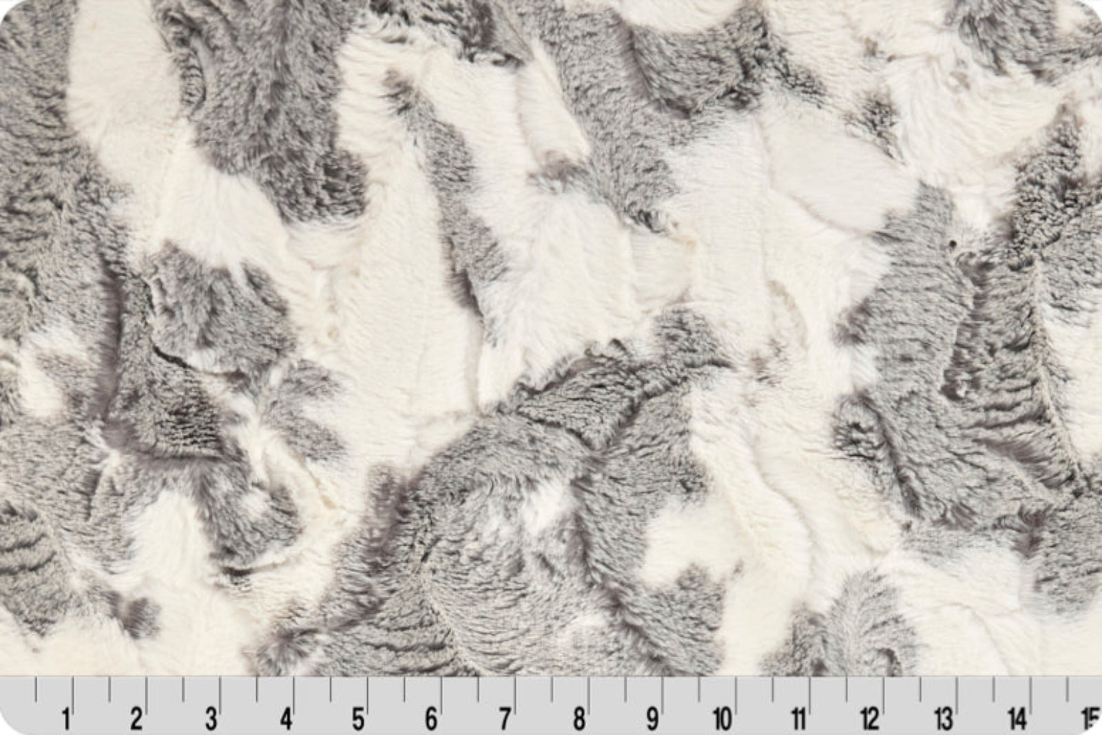 Close-up of textured gray and white fabric with a ruler at the bottom.