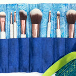 Makeup brush roll with turquoise interior and embroidered floral exterior, shown open and closed.