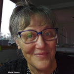 Portrait of Handi Quilter educator Marla Simms wearing glasses and smiling indoors