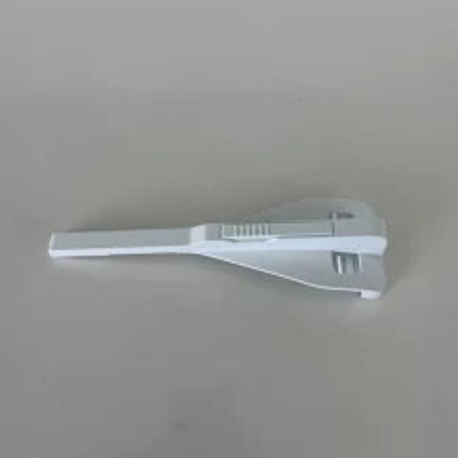 A white plastic seam guide for a sewing table