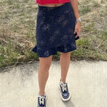 Person wearing a handmade skort from the Sulky Tee & Skort Workshop, shown in a front view with a ruffled hem and star‑patterned fabric.