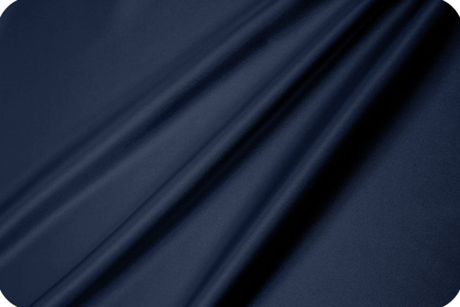 A close-up of draped navy blue fabric with soft folds and a smooth texture.