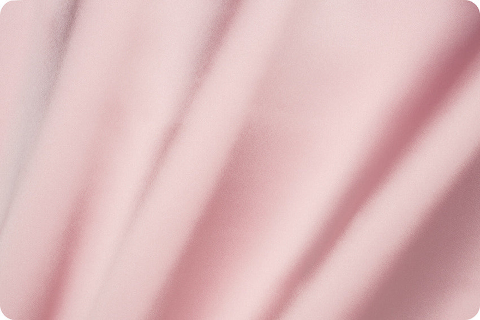 A close-up of soft pink fabric with gentle folds and a smooth texture.