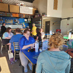 Main floor of Barley Pop Brewing with people gathered at tables for Stitch ’n Bitch