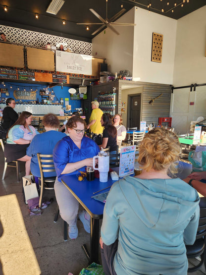Main floor of Barley Pop Brewing with people gathered at tables for Stitch ’n Bitch