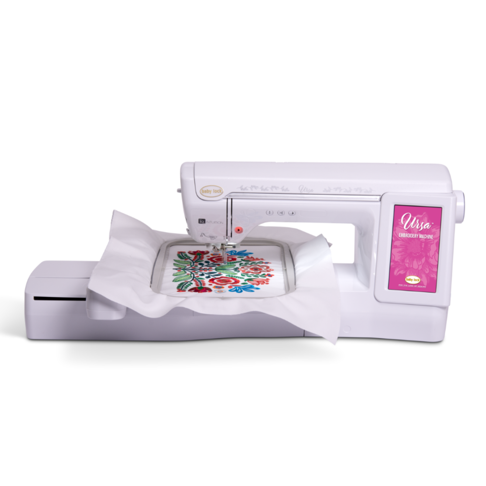 A white sewing machine with a digital display screen on the right side, shown with a white fabric arm holding a colorful floral embroidery pattern.