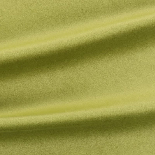 Close-up of green velvet fabric with folds to show texture