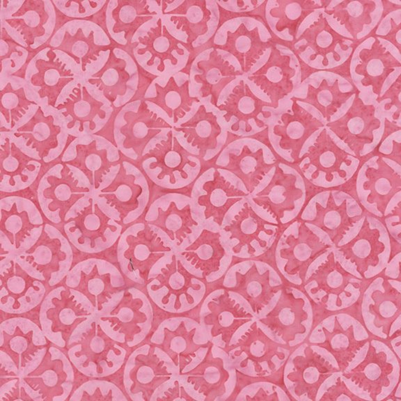 A close-up of a pink patterned fabric or material swatch with a repeating floral and geometric motif in slightly darker pink.