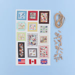 Sheet of quilt patterns with flags and wooden clips on a blue background