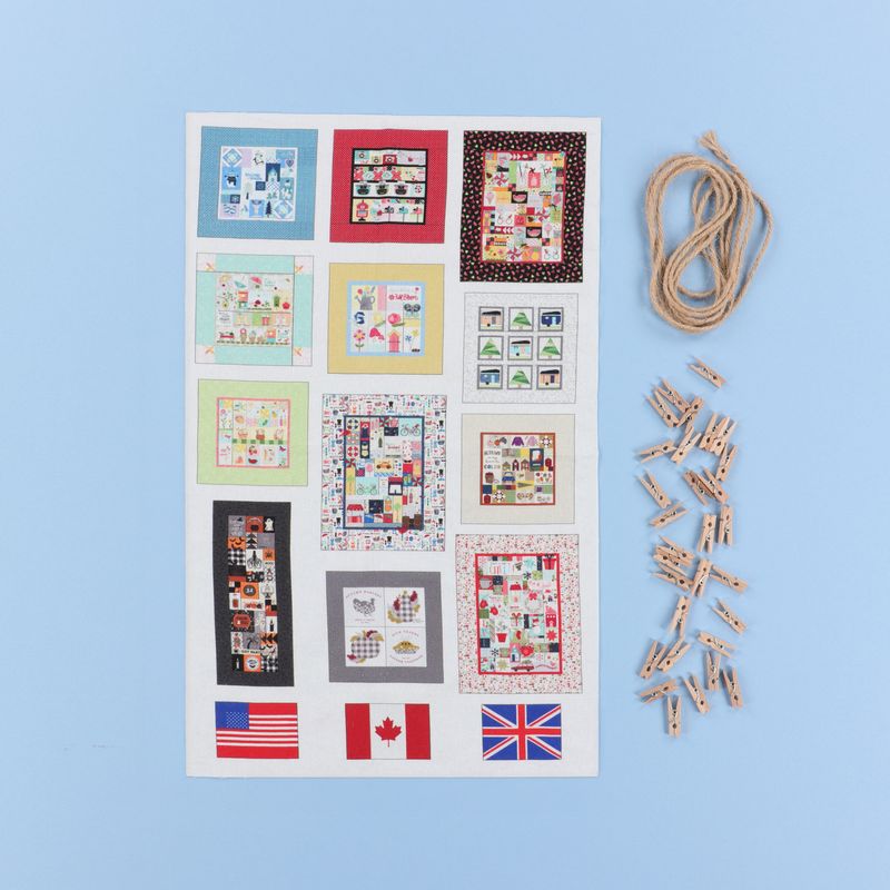 Sheet of quilt patterns with flags and wooden clips on a blue background
